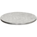 A Tablecraft translucent clear aluminum table cover with a random swirl design on a round white table top.