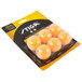 A plastic container with a pack of orange Stiga ping pong balls.