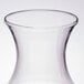 A clear plastic WNA Comet Reserv wine carafe with a small amount of liquid in it.