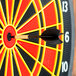 A black Arachnid soft tip dart in the center of a dart board.