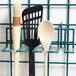 A Metro SmartWall G3 small utensil holder with kitchen utensils on a rack.