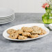 A Villeroy & Boch white porcelain oval platter with cookies on a table.