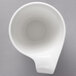 A Villeroy & Boch white porcelain mug with a handle on a gray background.