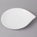 A white Villeroy & Boch porcelain flat plate on a gray surface.