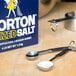 A box of Morton Iodized Table Salt sitting next to measuring spoons on a counter.