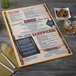 A Menu Solutions Hamilton Mandarin menu board on a table with a bowl of food.