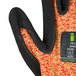 A close up of a pair of Cordova heavy duty work gloves with a black and orange design.