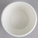 A white Villeroy & Boch porcelain sugar bowl with a lid on a gray surface.