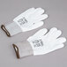 A pair of large white Cordova warehouse gloves with white polyurethane coating on the palms.