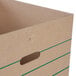 A close up of a rectangular Lavex cardboard box with green stripes.