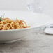 A Villeroy & Boch premium porcelain pasta plate with noodles on a table.