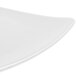 A CAC Festiware white triangle flat plate with curved edges.