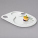 A Villeroy & Boch white porcelain bento party plate with small food on it.