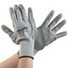 A pair of Cordova Caliber warehouse gloves with gray polyurethane palms on a white background.