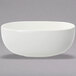A Villeroy & Boch white porcelain salad bowl with a small rim on a gray background.