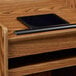 A black rectangular tablet on a wooden Oklahoma Sound Aristocrat lectern.