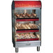 An Alto-Shaam heated countertop display case with pastries on shelves.