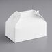 A white Barn take-out box with a handle.