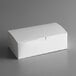 A 9" x 5" x 4 1/2" white take out dinner / chicken box with a tuck top lid.