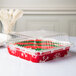 A Durable Packaging clear plastic container with a red and green holiday cake inside.