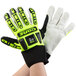 A pair of Cordova OGRE lime green heavy duty work gloves with black and neon yellow design on a person's hands.