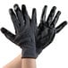 A pair of gray and black Cordova work gloves with black nitrile palms.