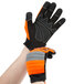 A person wearing Cordova Colossus orange and black warehouse gloves.