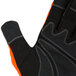A close up of a Cordova Colossus Hi-Vis Orange work glove with black synthetic leather palm and orange stitching.