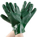 A pair of hands wearing green Cordova PVC gloves with jersey lining.