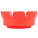 A red ashtray with three notches on the rim.