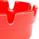 A close up of a red Choice plastic ashtray.