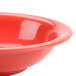 A close up of a red Thunder Group melamine soup bowl.