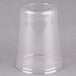 A clear plastic cup on a gray surface.
