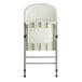 A white Lancaster Table & Seating folding chair with a charcoal frame.