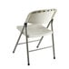 A white folding chair with a metal frame.