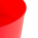 A red plastic base for a beverage dispenser with a white background.