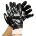 A pair of black Cordova PVC gloves with white lining.