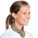 A woman wearing a white chef's coat and a beige Intedge chef neckerchief smiling.
