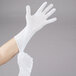 A person wearing white Cordova Lightweight cotton inspection gloves.