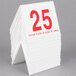 A stack of white Cal-Mil table tents with red numbers on them, the top one showing "25"
