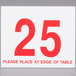 A white sign with red numbers reading "1 to 25" on a table.