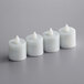 A row of Sterno warm white flameless tea lights on a grey surface.
