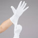A hand wearing Cordova white inspector's gloves.