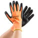 A pair of Cordova Hi-Vis Orange and black gloves with black foam nitrile palms and orange tips.