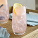 Two glasses of Narvon pink lemonade with a lemon slice in one glass.