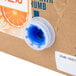 A white and blue box with a plastic spout for Narvon Orange Juice Syrup.