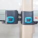 A close up of blue and gray plastic clips on a MetroMax Q metal shelving unit.