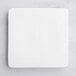 An Acopa bright white square porcelain plate on a marble surface.