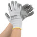 A pair of large Cordova cut resistant gloves with gray palm coating and yellow trim.