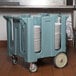 A blue Cambro dish dolly cart filled with stacked plates.
